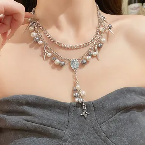 Close-up of a double-layered necklace featuring grey pearls and a star pendant