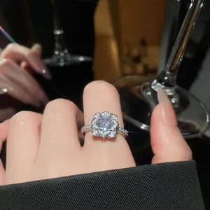 Detailed close-up showing the sparkling zircon flower setting of a silver open ring