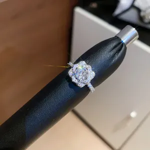 Close-up of a sparkling floral zircon ring with brilliant starburst lens flare effects.