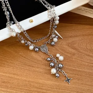 Detailed view of silver double-layered necklace with grey pearls and star charms