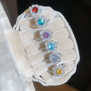 Group of sparkling flower-shaped rings with colorful zircon stones in a jewelry box