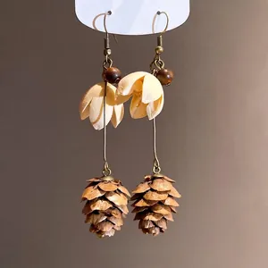 Vintage forest style earrings featuring realistic pine cone pendants and wooden beads detail