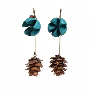 Vintage forest style drop earrings featuring turquoise flower and realistic pinecone pendant