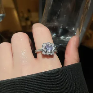 Detailed close-up of a luxury sparkling flower-shaped zircon open ring on a finger