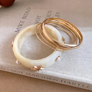 Bohemian resin bangle set with gold starfish and pearl accents for beach holidays