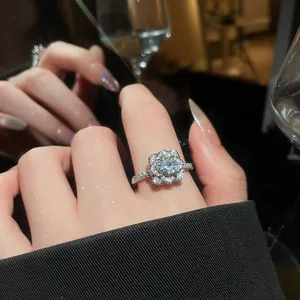 Close-up of sparkling zircon flower ring on finger showcasing exquisite and luxury details