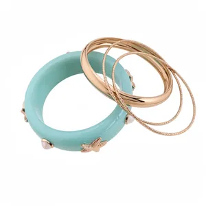 Bohemian mint resin bangle set with gold starfish and pearl accents on white background