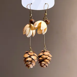 Elegant vintage forest-style earrings featuring petals and pinecone pendants for boho look