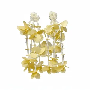 Elegant yellow tassel disk earrings with 18k gold plated finish on white background