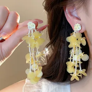 Close-up of elegant yellow floral tassel earrings with 18k gold plated silver needle
