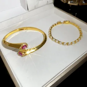 Vista dettagliata del bracciale rigido placcato oro 18k e bracciale tennis in zirconi.
