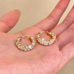 Close-up detail of luxury 14k gold plated hoop earrings with sparkling cubic zirconia