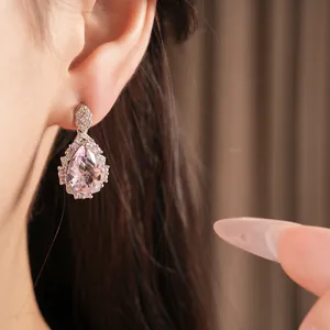 Detailed close-up of pink zircon teardrop earrings with elegant palace style design.