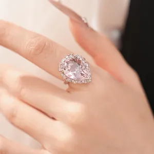 Macro detail of luxury pink pear-shaped zircon ring with ornate vintage palace design