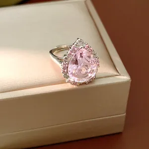 Close-up detail of an elegant pink water drop zircon ring with a polished silver finish