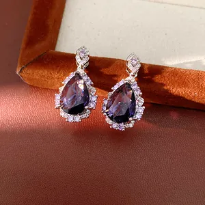 Detail showing elegant teardrop purple zircon earrings with royal style silver setting