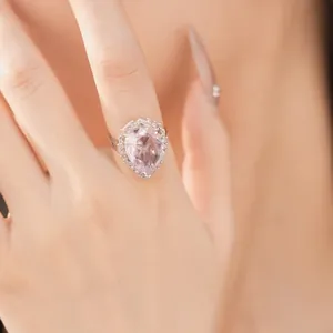 Close-up of a pink waterdrop zircon ring with palace style and light luxury design.