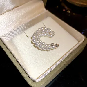 Macro view showing the elegant texture of French vintage triple-layer pearl ear cuff