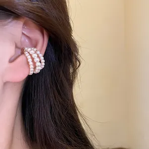 Elegant three-layer vintage pearl beaded ear cuff shown on an Asian model ear detail
