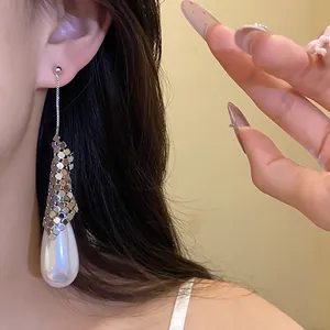 Detailed view of silver-tone waterdrop pearl earrings with shimmering mesh accent.