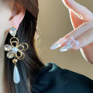 Detailed macro shot of elegant court-style flower earrings with pearls and crystals