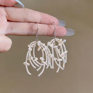 Elegant handmade shell tassel hook earrings with white beads for a summer resort look