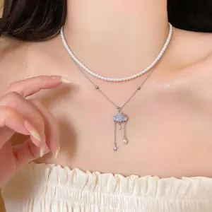 Close-up of a double-layer pearl and cloud pendant necklace for women's jewelry