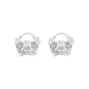 Elegant silver-tone floral hoop earrings with pearls and rhinestones on white background.