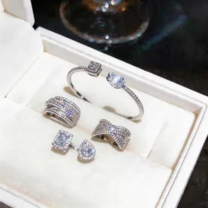 Sparkling silver-toned zircon jewelry set with rings, bracelet, and earrings in box
