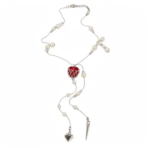 Elegant long pearl beaded necklace featuring a red heart pendant and asymmetric charms