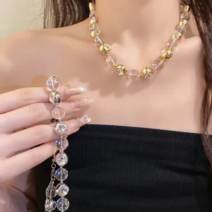 Detailed view of fashionable beaded necklace with clear beads and sparkling rhinestones.