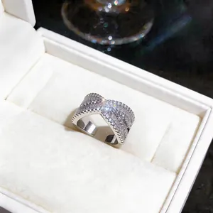 Detailed view of a silver crossover X-shaped ring set with sparkling cubic zirconia