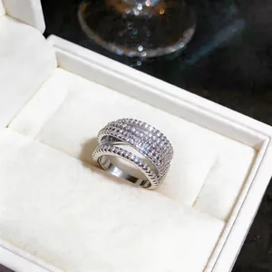 Macro detail of a luxurious silver crisscross ring studded with sparkling zircons.