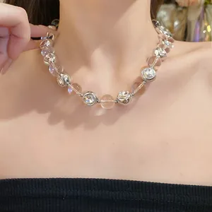 Close-up view of an elegant rhinestone beaded necklace worn on a model neck area