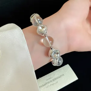 Close-up detail of an elegant clear beaded bracelet featuring sparkling rhinestone settings