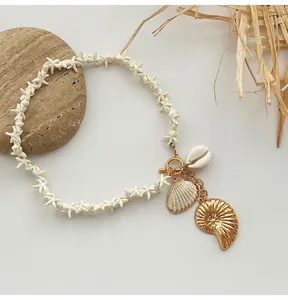 Detailed view of Bohemian starfish bead necklace with golden nautilus and shell charms