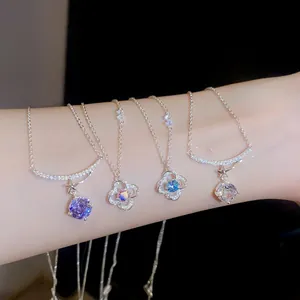 Close-up of four floral zircon pendant necklaces on an arm with sparkling crystals