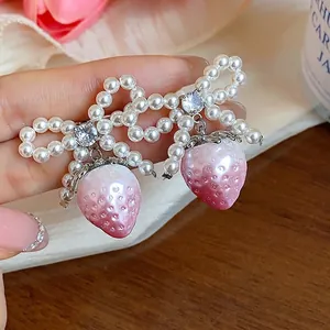 Sweet strawberry pearl bow earrings featuring pink gradient charms and crystal accents