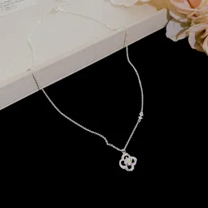 Close-up of elegant silver necklace with iridescent zircon flower pendant detail