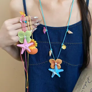 Detailed view of colorful starfish and shell charms on a vacation style necklace