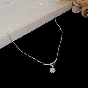 Close-up of elegant zircon flower pendant necklace on a premium black background