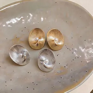 18k gold and silver plated oval textured stud earrings with pearl center detail