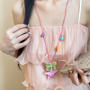 Close-up of handmade starfish and shell flower necklace for beach vacation outfits