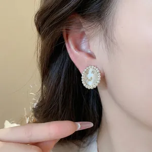 Elegant 14k gold plated smiley face stud earrings with pearl border and cat-eye stone detail