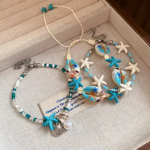 Detailed view of beach-style bracelets with shells and starfish in a jewelry tray