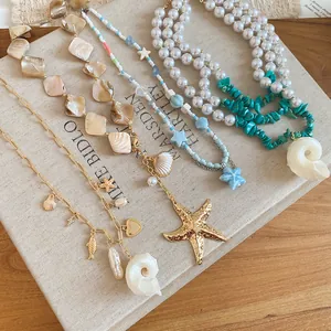 Detail view of assorted beach vacation necklaces with natural shells, pearls and starfish charms