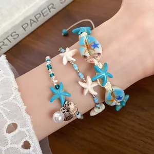 Close-up of beach style shell and starfish beaded bracelets for a summer vacation look