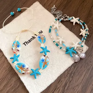 Detailed close-up of beach vacation style bracelets featuring starfish and shells