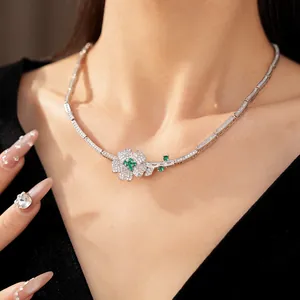 Close-up of green and white zircon flower necklace on model's neck