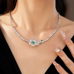 Detailed close-up view of an elegant green zircon flower necklace worn by a model